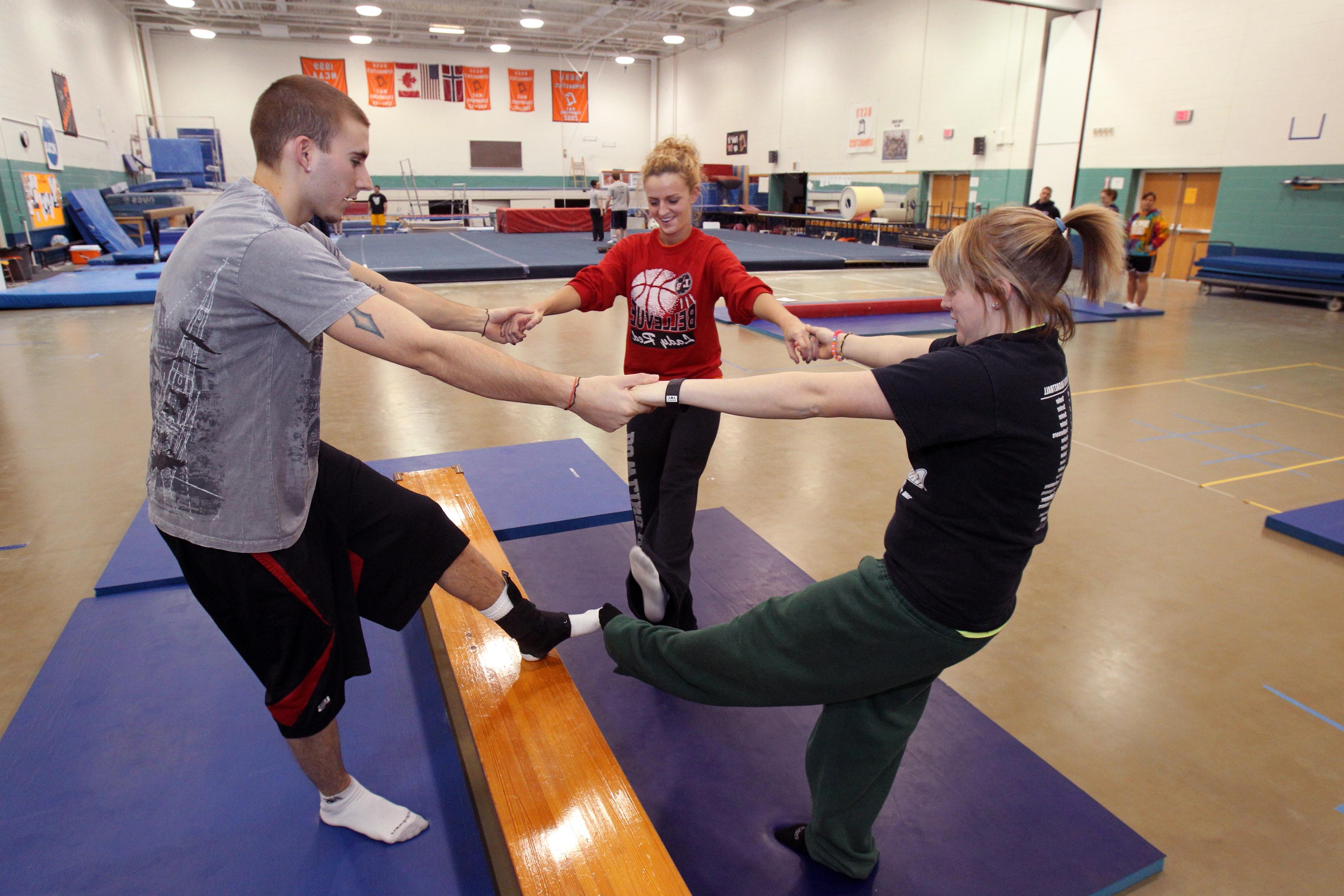 Three BGSU Kinesiology master's students practice strength exercises in a dedicated Fitness Center on our Ohio campus.